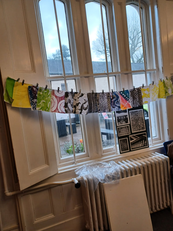 Washing line with print samples pegged on it to dry.