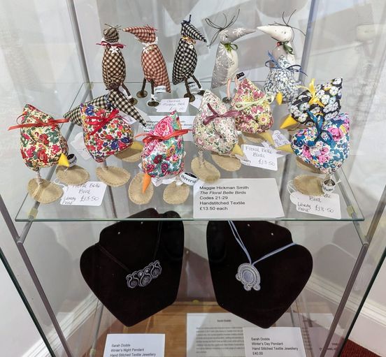 A collection of fabric birds and soutache jewellery.